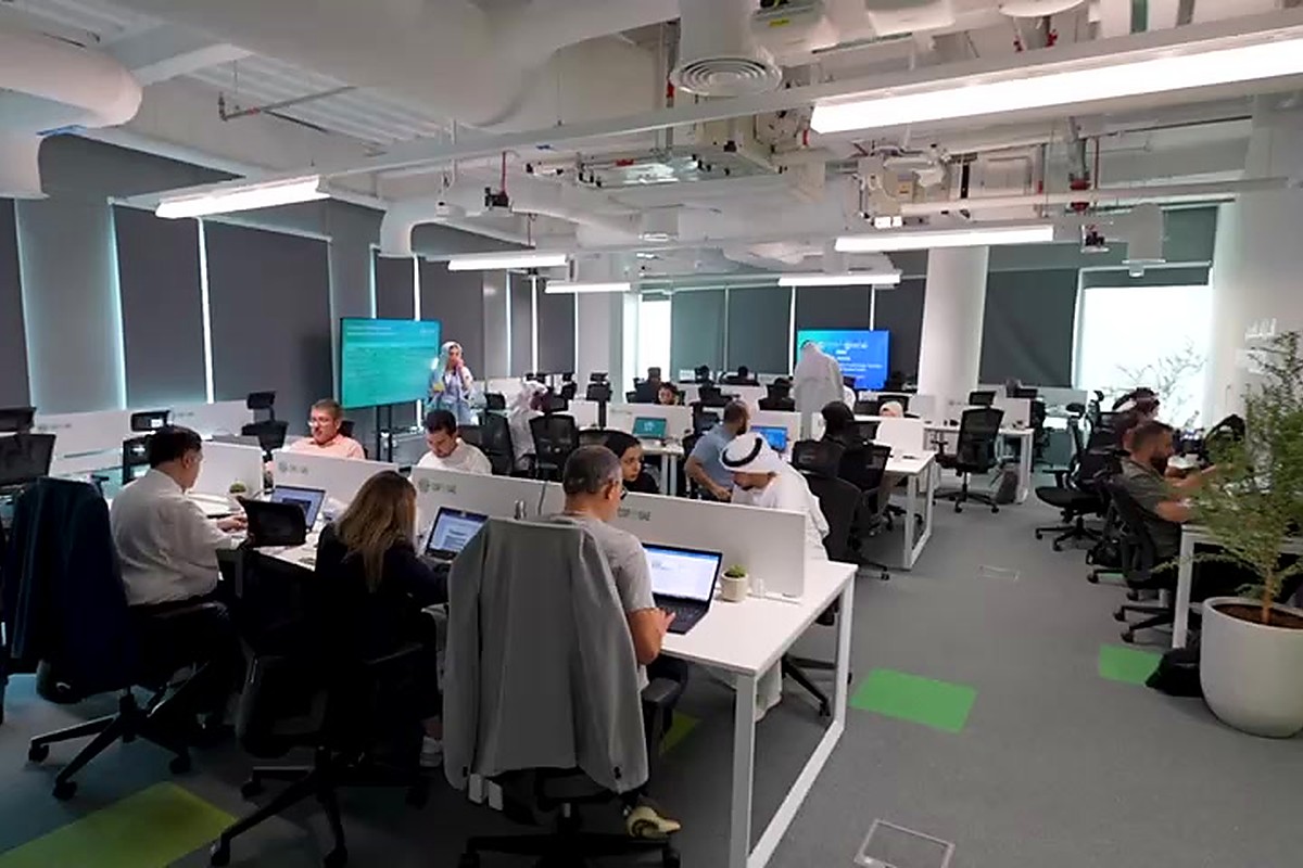 Journalists working at desks in a summit media centre