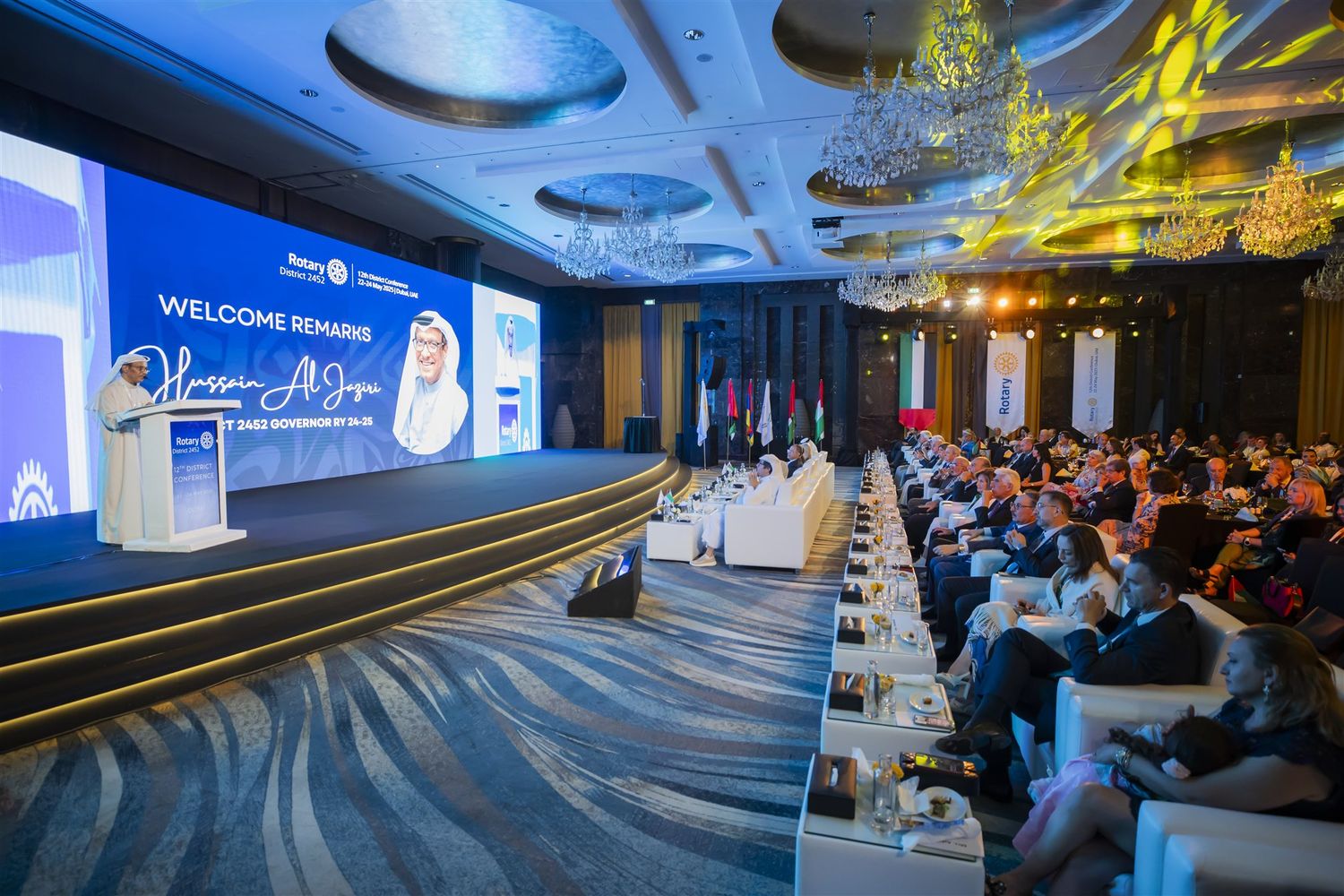 Opening remarks to a seated audience at a district conference in Dubai