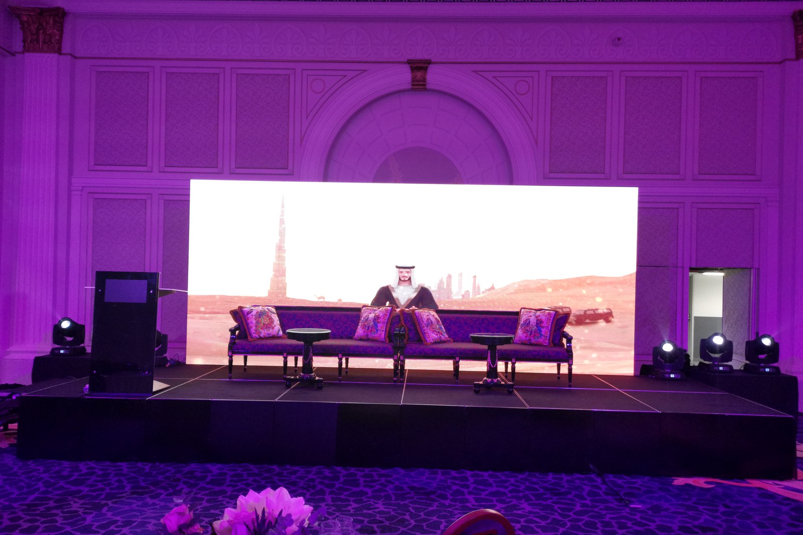Stage set with seating in front of a wide LED wall